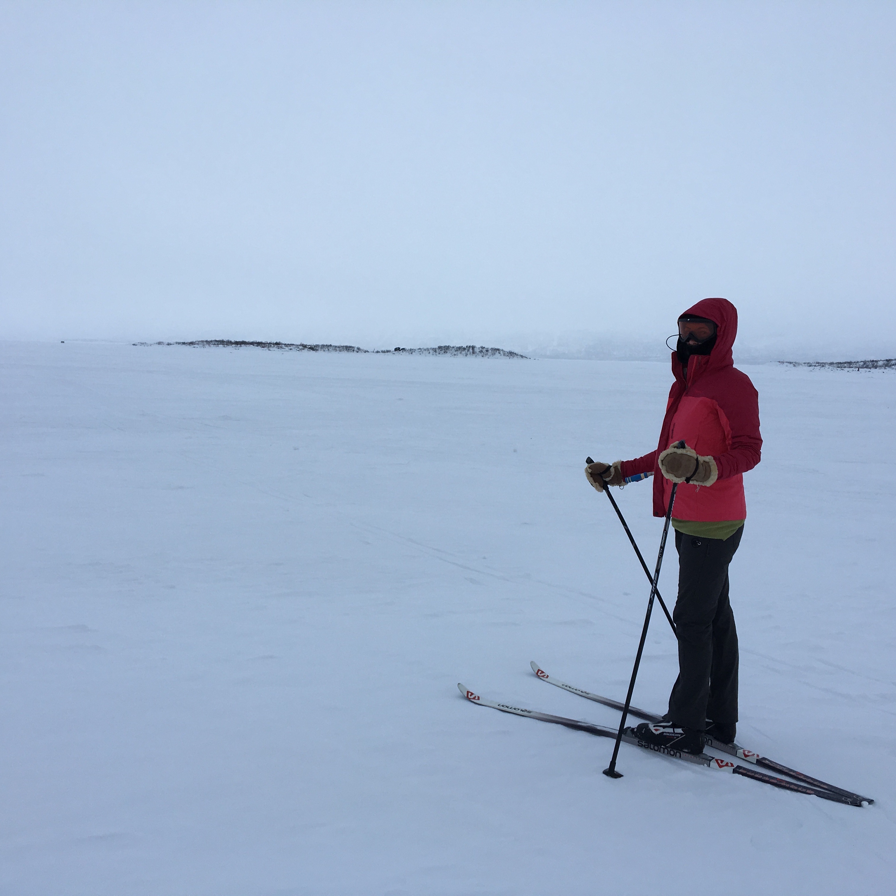 Skiing across the frozen lake near Abisko surrounded by a white-out blizzard.