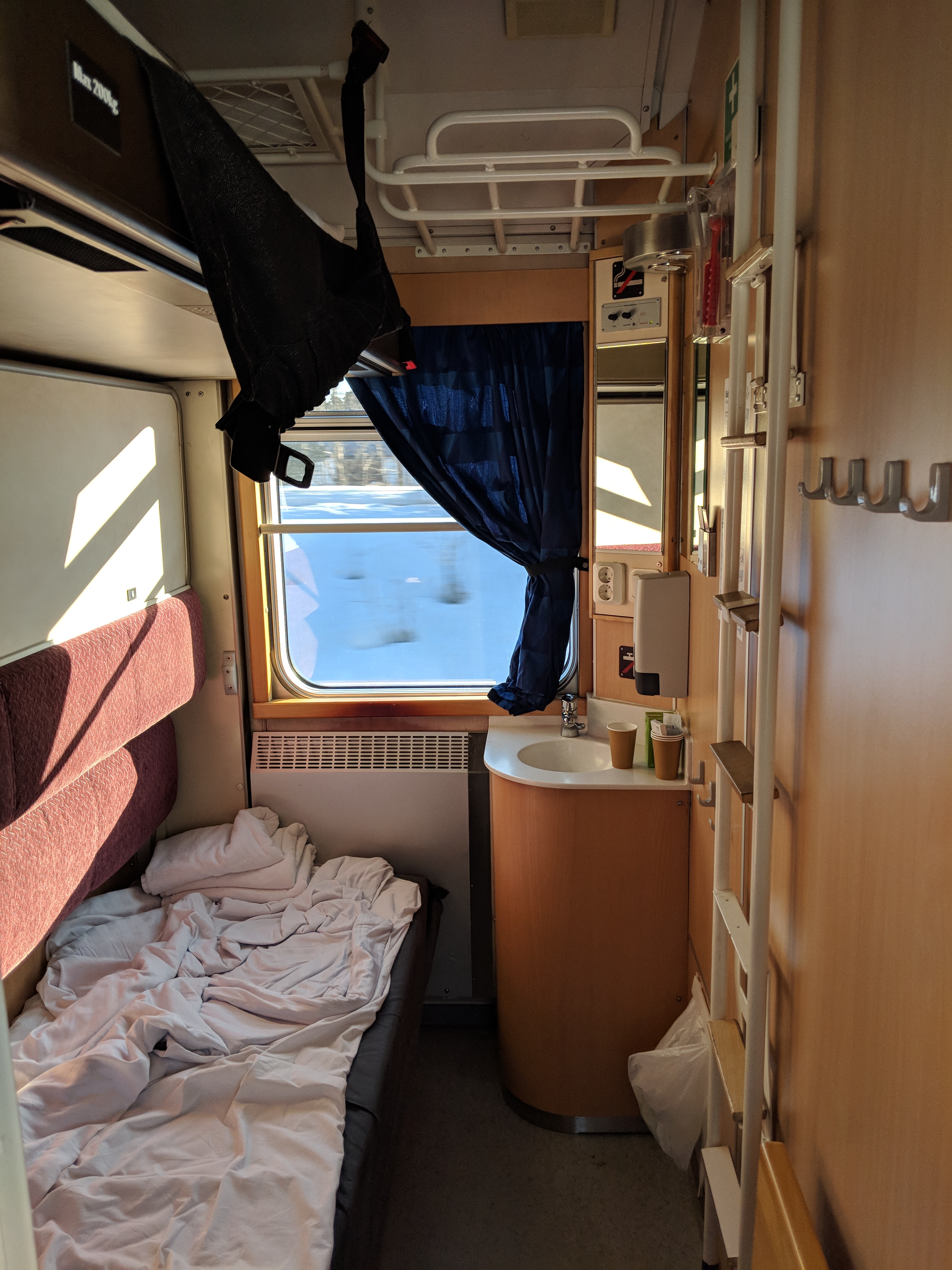 Eensy weensy 3-person train car. The board above the bottom bunk folds out to hold a 3rd person.
