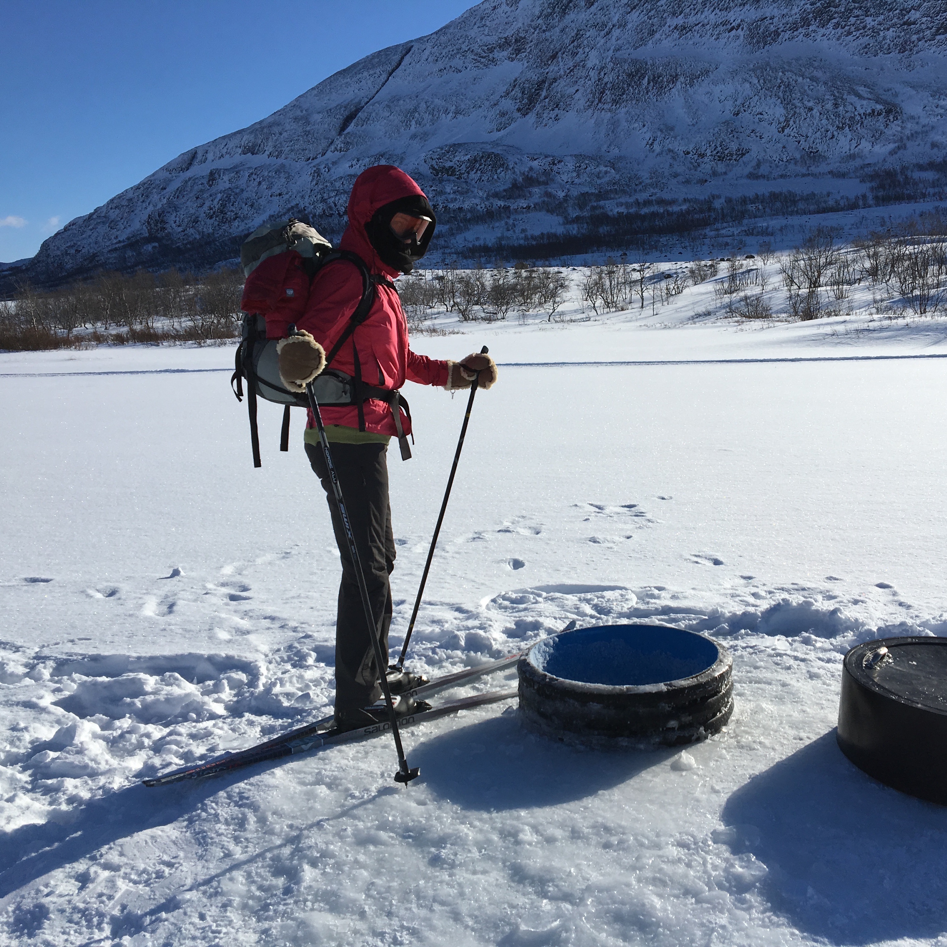 Water hole chopped in thick ice in the lake